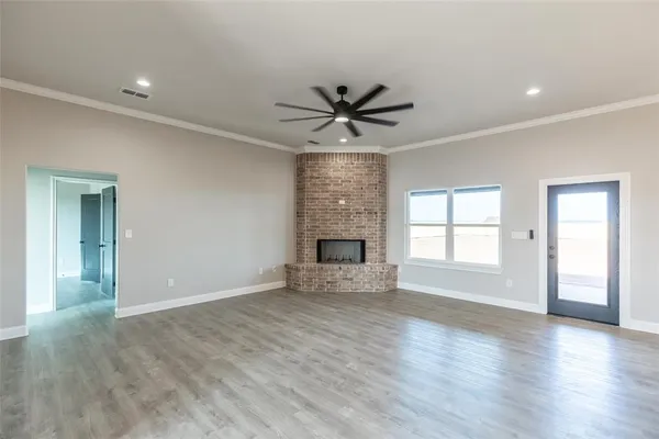 a large white kitchen with a large window appliances and cabinets