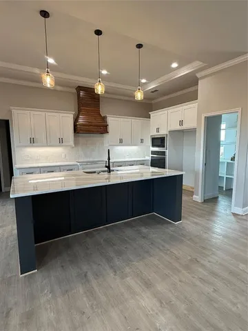 a open kitchen with stainless steel appliances granite countertop a sink a stove and a refrigerator
