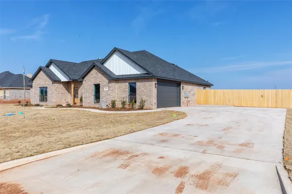 a view of a house with a wooden fence