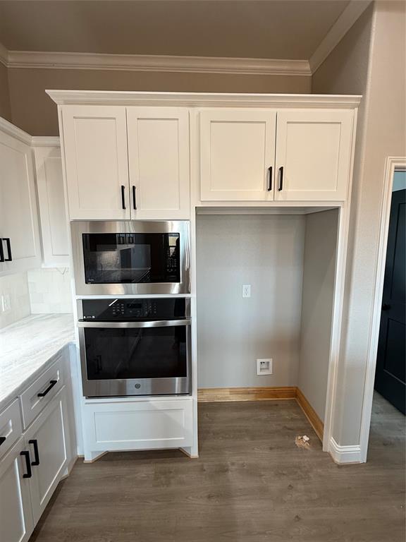 239 Indian Ridge Road Tuscola, TX 79562 - Photo 5 of 26 a kitchen with white cabinets and stainless steel appliances