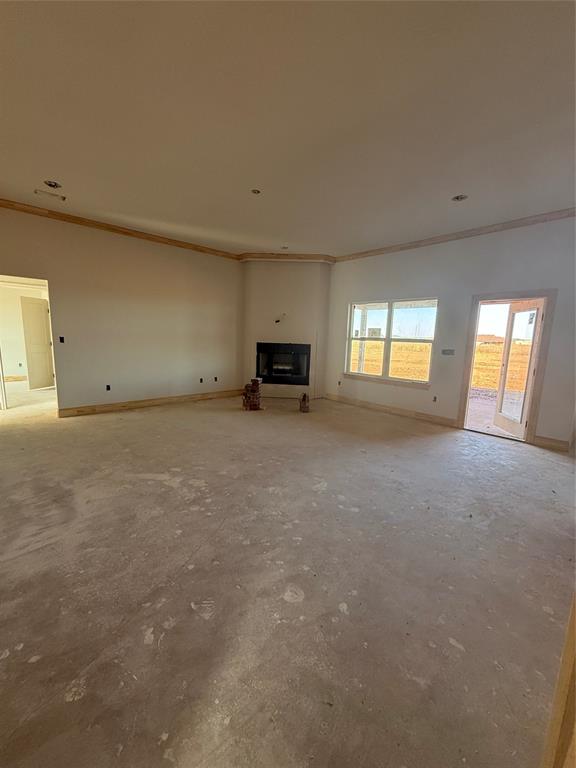 239 Indian Ridge Road Tuscola, TX 79562 - Photo 6 of 24 a view of an empty room with a window and fireplace