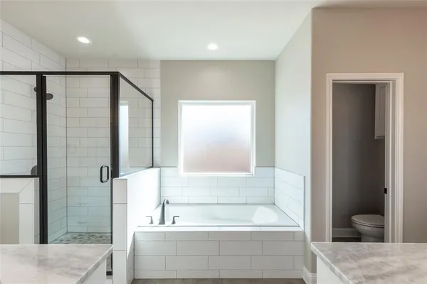 a spacious bathroom with a double vanity sink a mirror and a shower