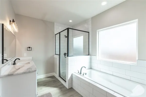 a bathroom with a shower and a sink