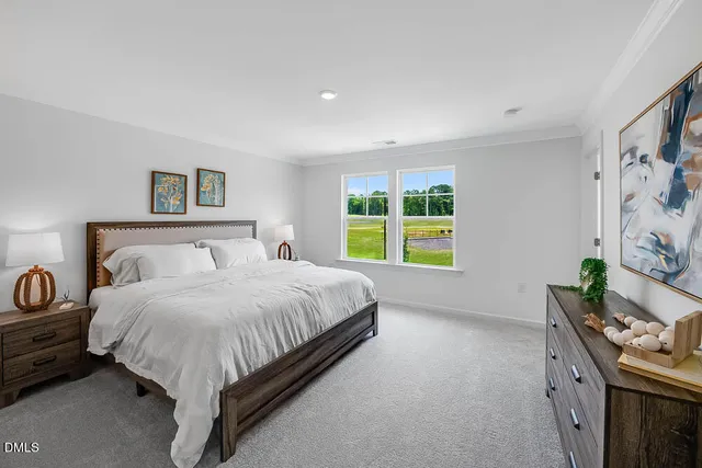 a bedroom with a bed and a large window