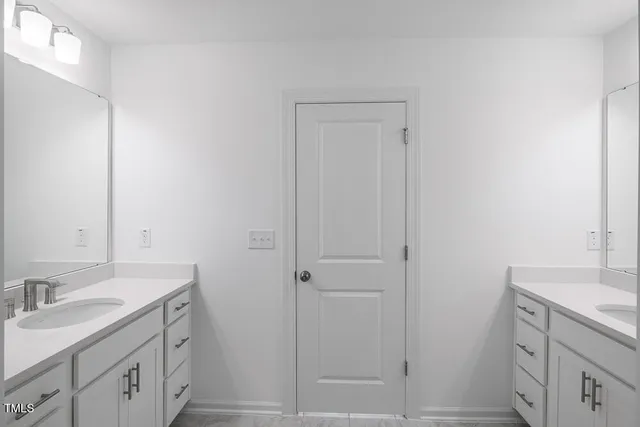 a bathroom with a shower sink and mirror