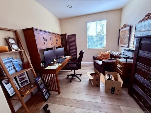 a living room with furniture a flat screen tv and a window