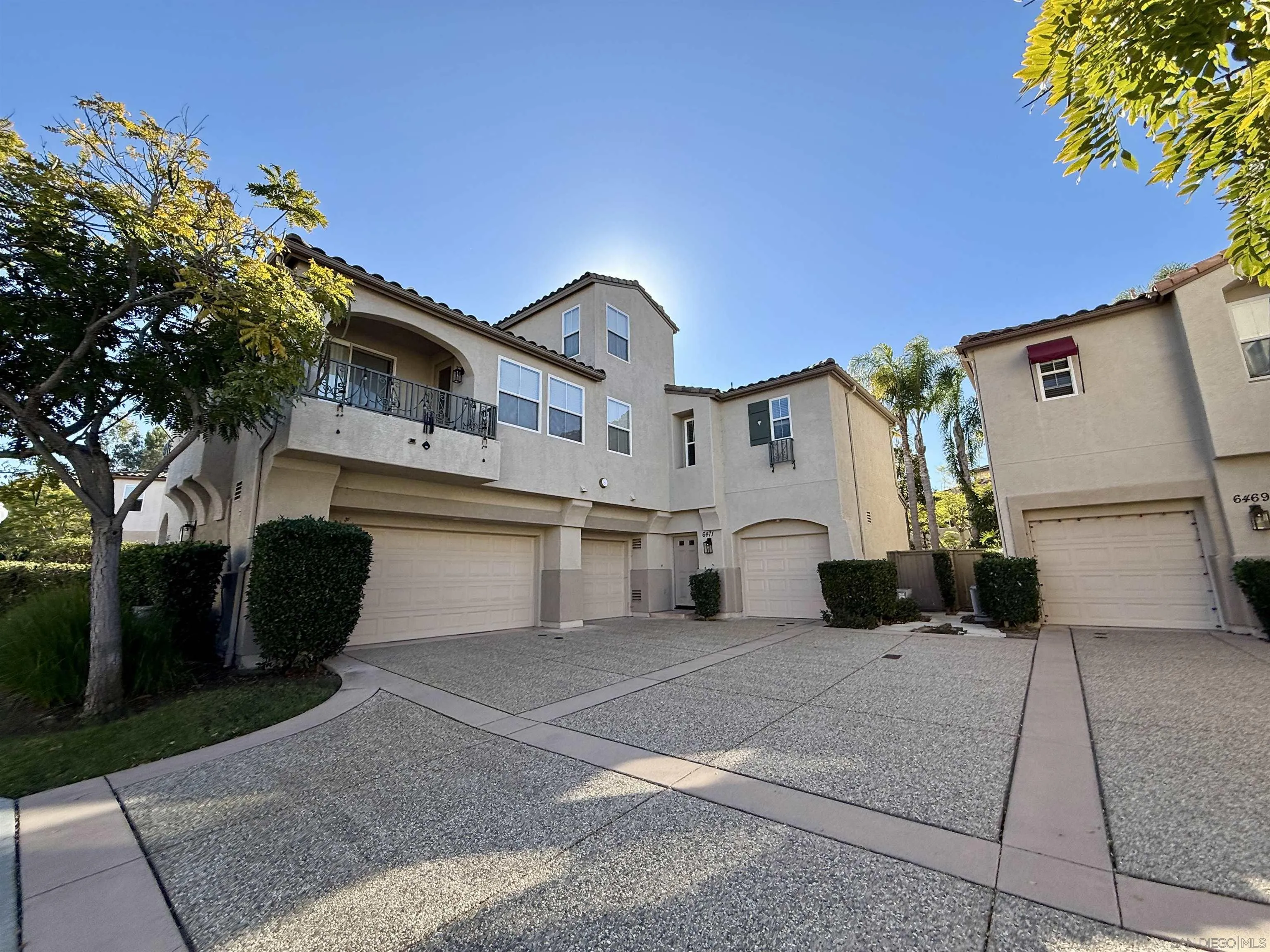 6471 Terraza Portico Carlsbad, CA 92009 - Photo 18 of 19 a front view of a house with a garage