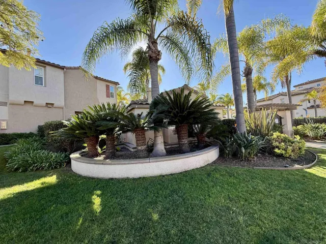 a view of a house with backyard and sitting area