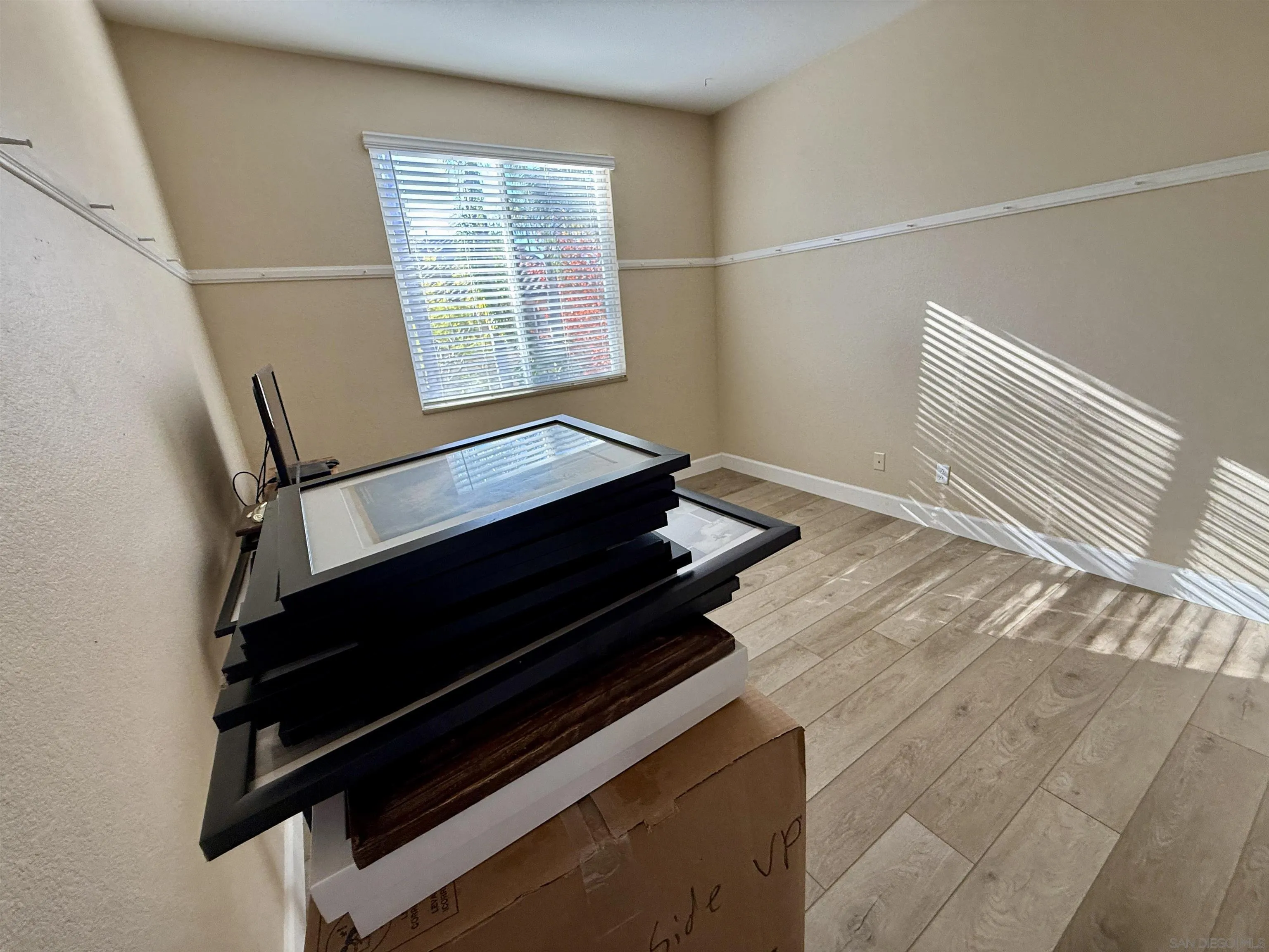 6471 Terraza Portico Carlsbad, CA 92009 - Photo 4 of 19 a view of an empty room with wooden floor and a window