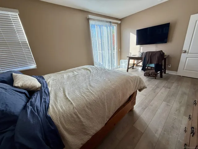 a bedroom with a bed and flat screen tv