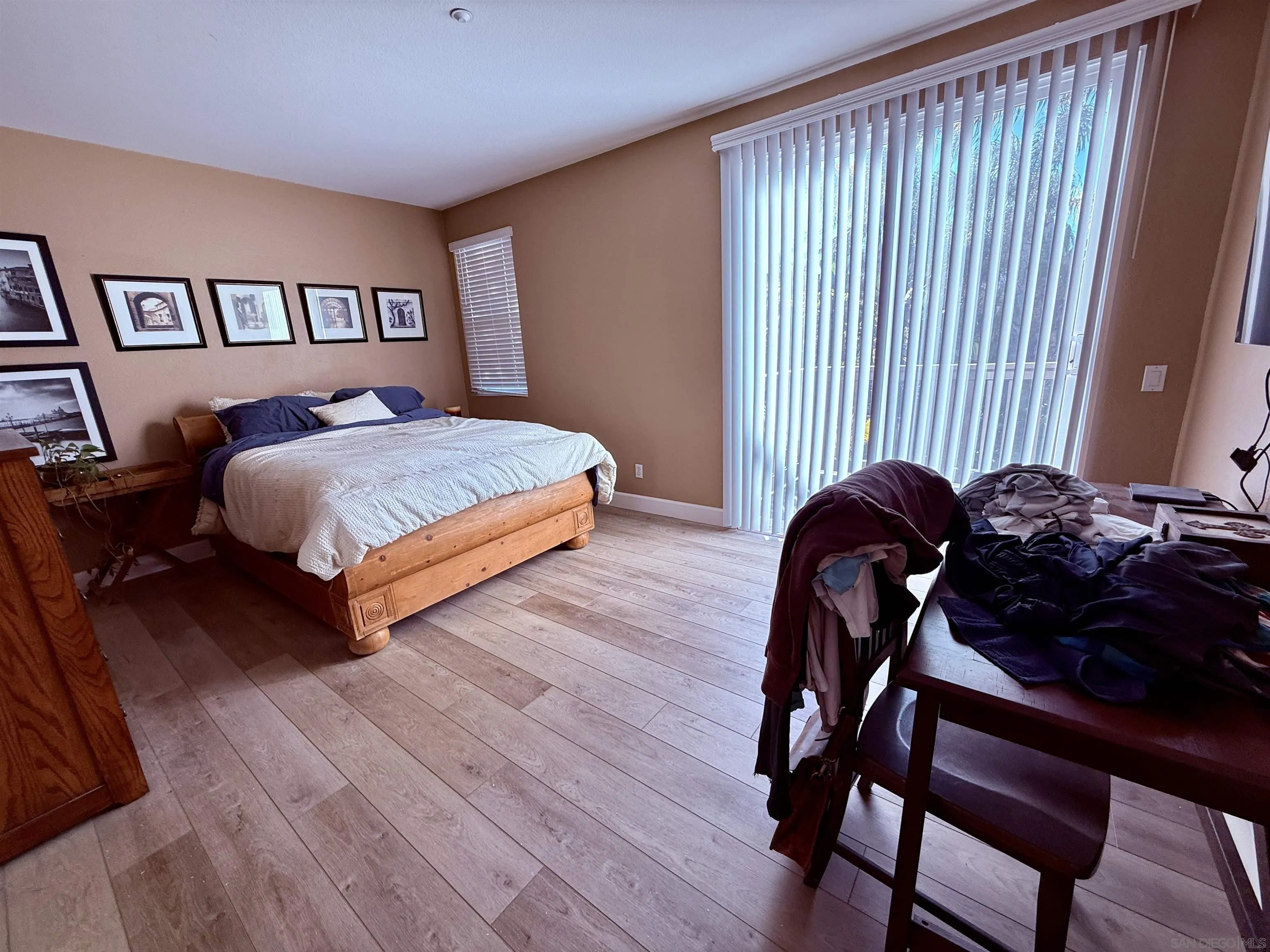 6471 Terraza Portico Carlsbad, CA 92009 - Photo 10 of 19 a bedroom with a bed and wooden floor