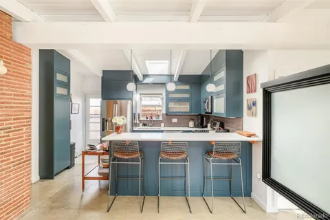 a kitchen with a sink cabinets and window