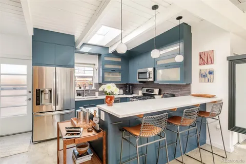 a kitchen with a sink a counter top stainless steel appliances and cabinets