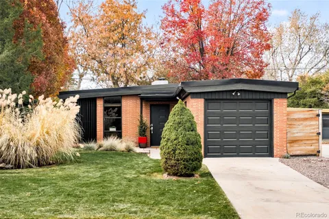 a front view of a house with a garden and plants