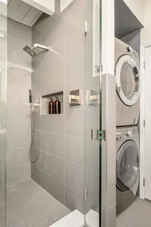a bathroom with a sink a washer and dryer