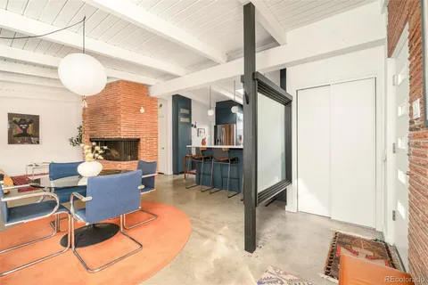 a living room with furniture a flat screen tv and a window