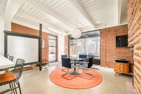 a room with furniture and large windows