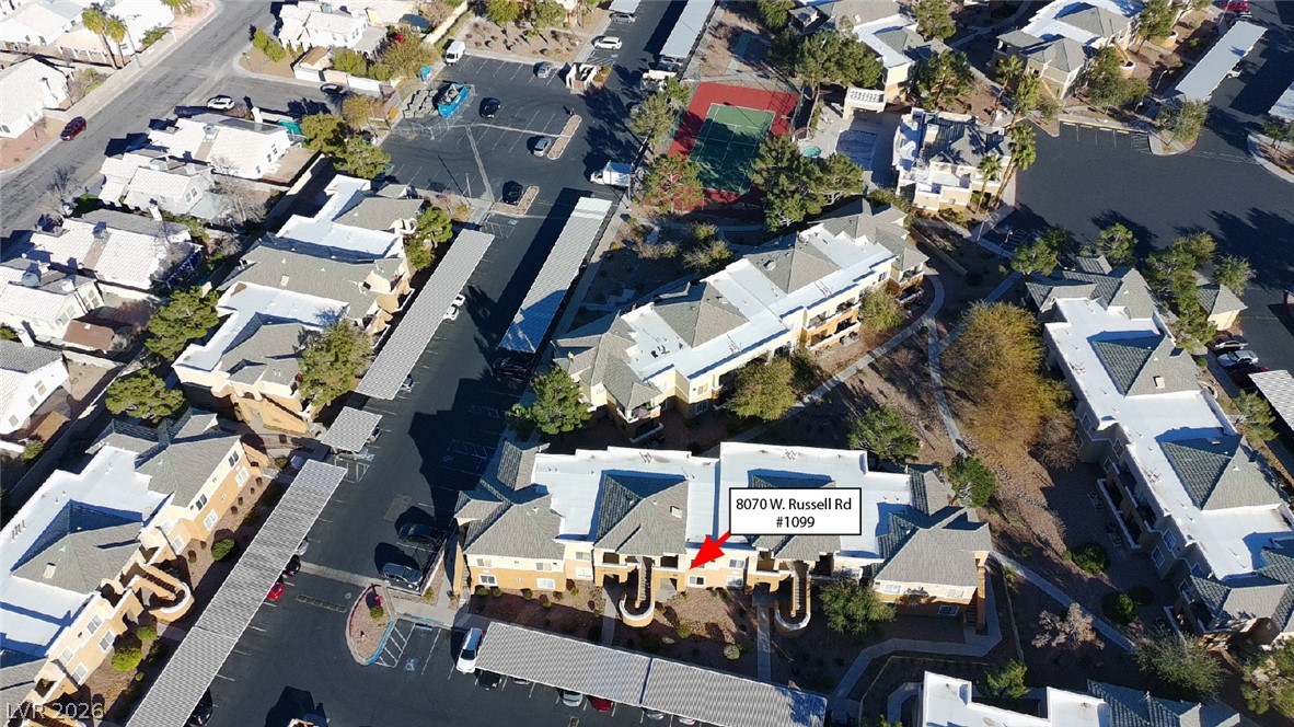 8070 West Russell Road, Unit 1099 Las Vegas, NV 89113 - Photo 2 of 31 An aerial perspective showcases a residential community with abundant parking, communal recreation, and well-maintained grounds.