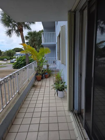 a view of a entryway door and potted plants