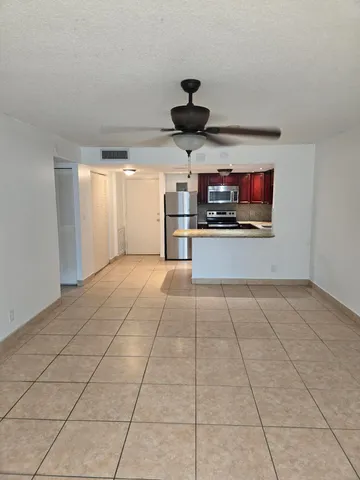 a kitchen with stainless steel appliances granite countertop a stove top oven a sink a counter top space and cabinets