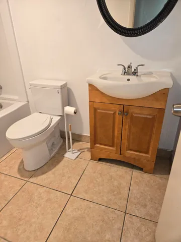 a bathroom with a sink toilet and mirror