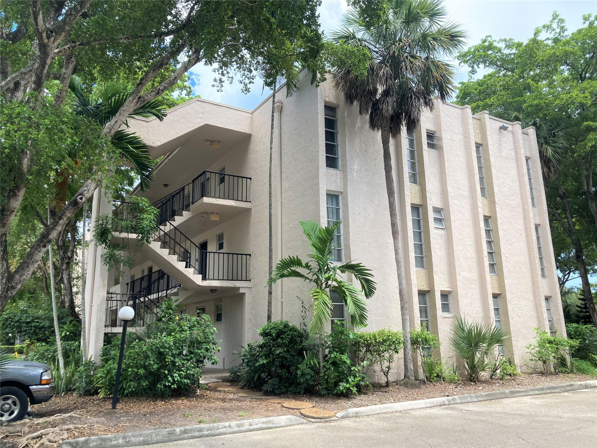 469 North Pine Island Road, Unit 308B Plantation, FL 33324 - Photo 1 of 16 a front view of white house with a tree