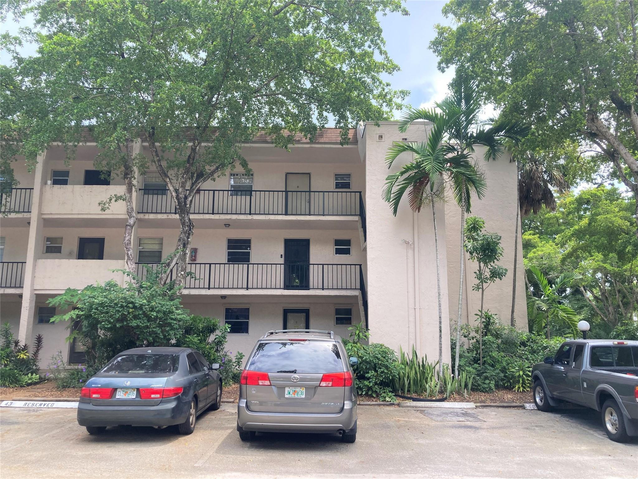 469 North Pine Island Road, Unit 308B Plantation, FL 33324 - Photo 13 of 16 a car parked in front of a white building