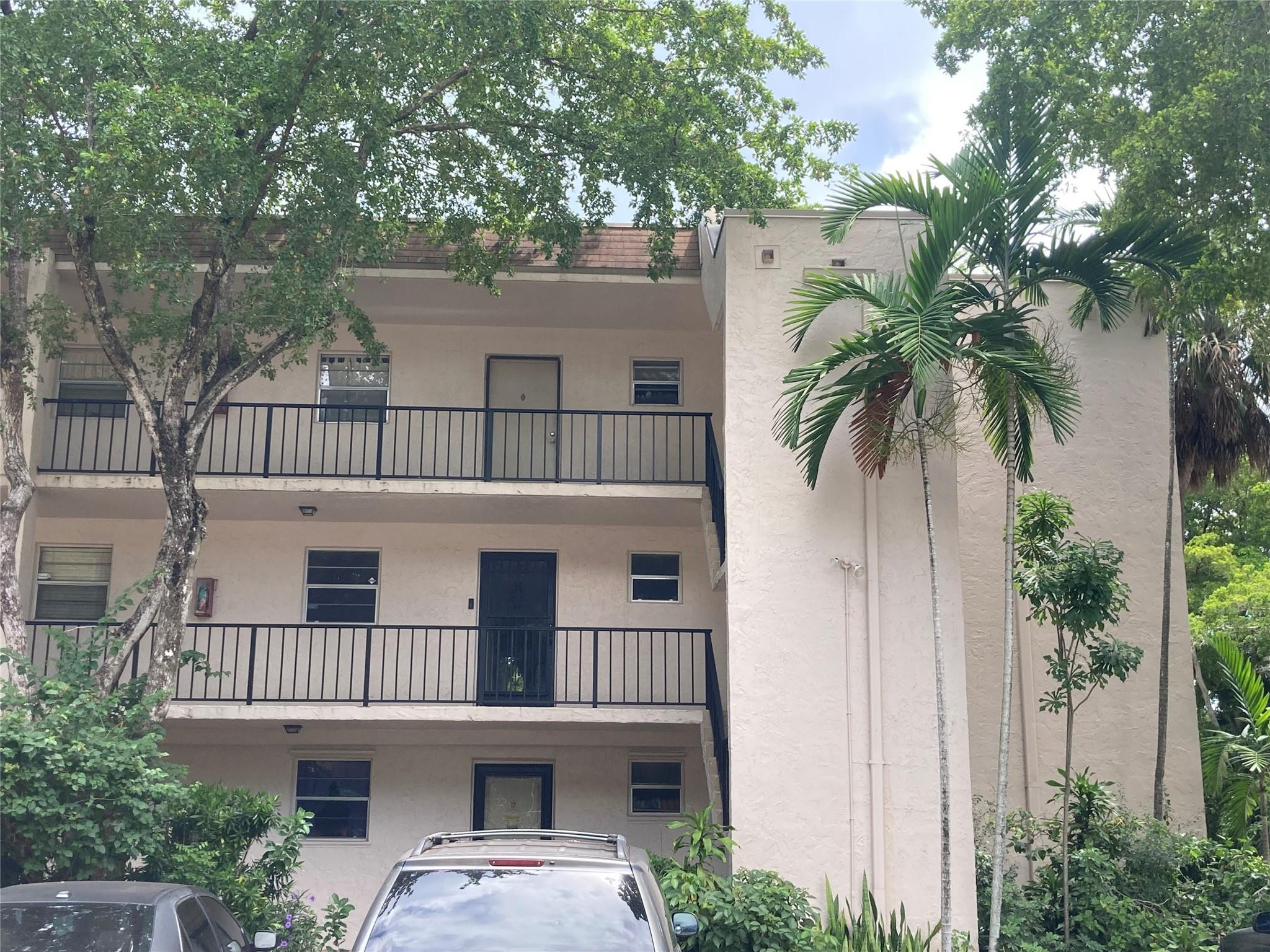 469 North Pine Island Road, Unit 308B Plantation, FL 33324 - Photo 14 of 16 front view of a house with a yard