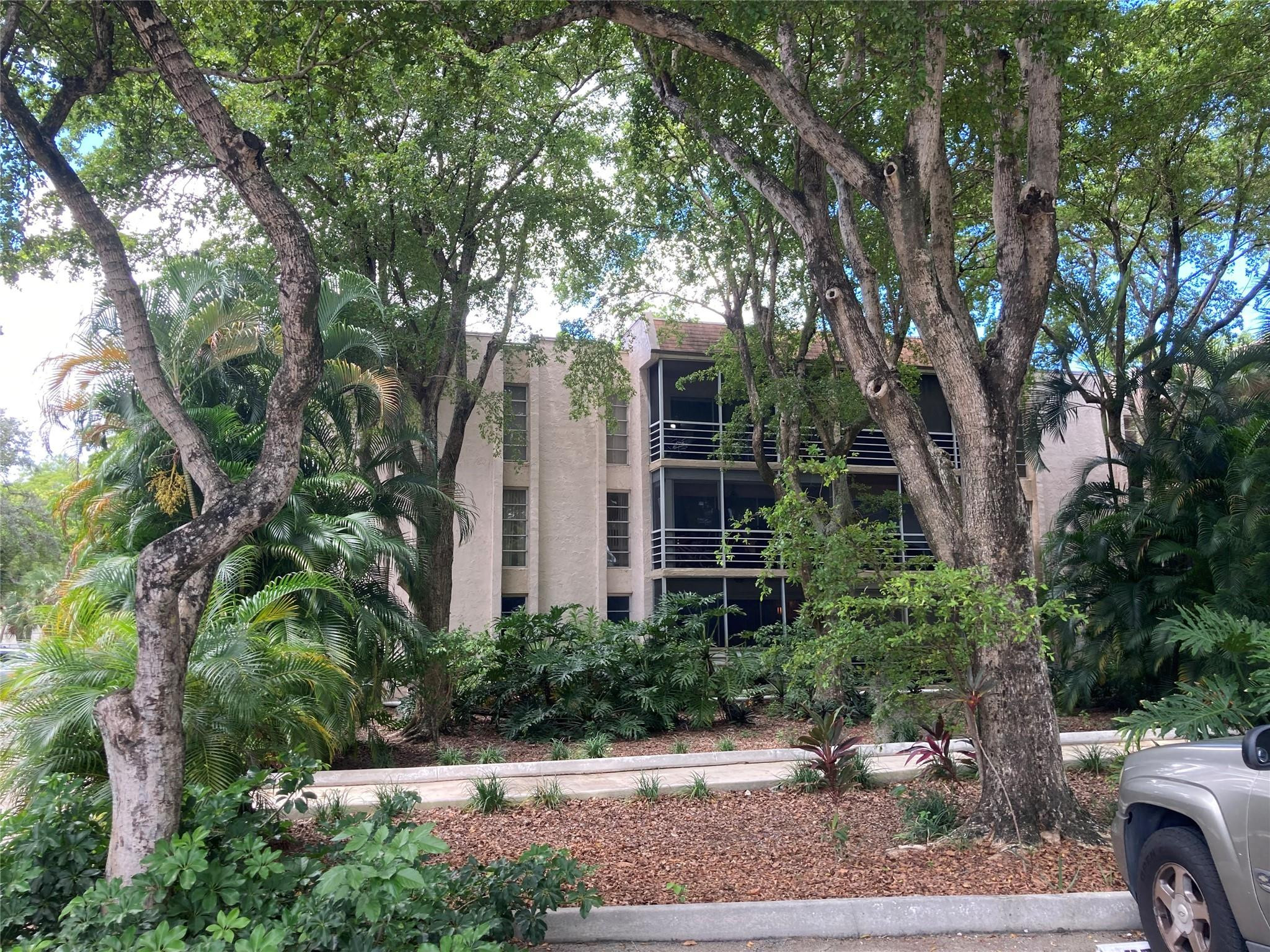 469 North Pine Island Road, Unit 308B Plantation, FL 33324 - Photo 16 of 16 a front view of a house with garden