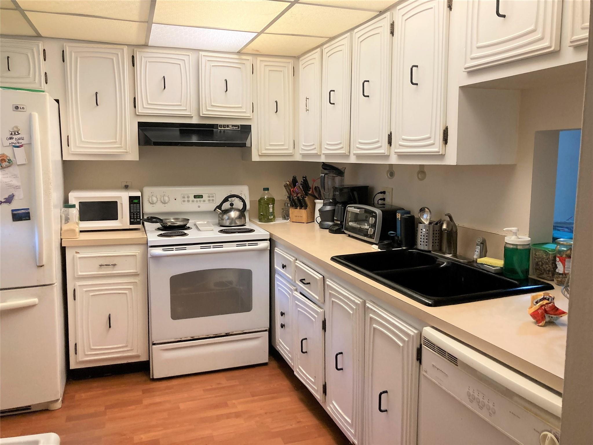 469 North Pine Island Road, Unit 308B Plantation, FL 33324 - Photo 4 of 16 a kitchen with white cabinets and white appliances