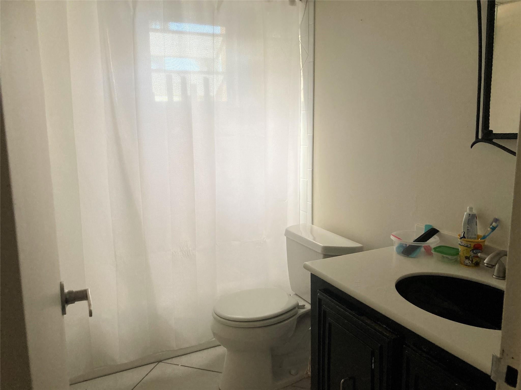 469 North Pine Island Road, Unit 308B Plantation, FL 33324 - Photo 7 of 16 a bathroom with a sink and a toilet