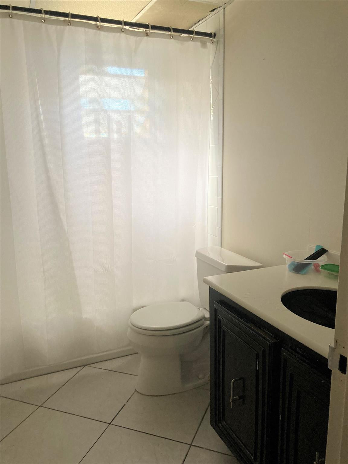 469 North Pine Island Road, Unit 308B Plantation, FL 33324 - Photo 8 of 16 a bathroom with a granite countertop sink toilet and shower