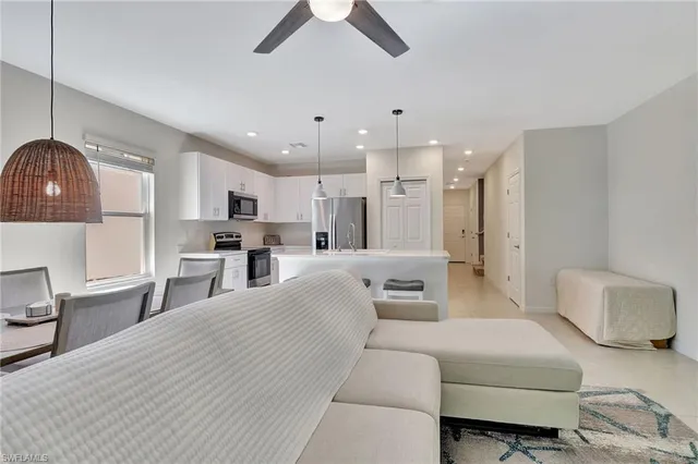 a living room with furniture and a ceiling fan