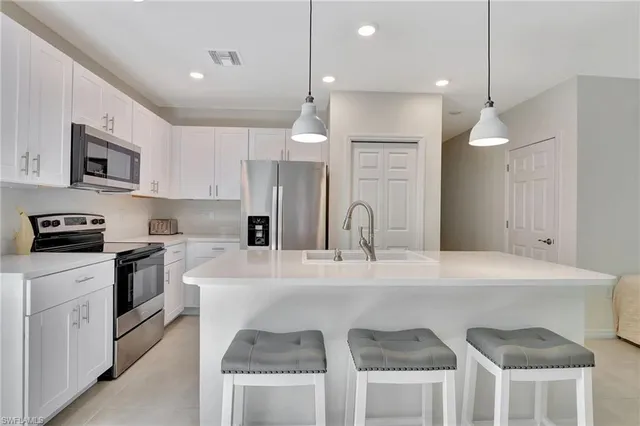 a living room with furniture and kitchen view