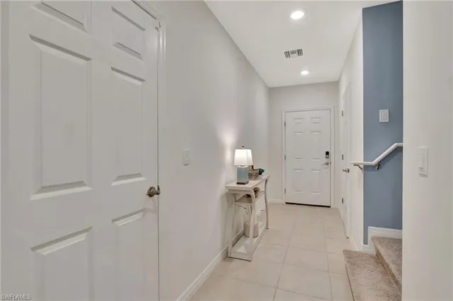 a kitchen with kitchen island white cabinets and stainless steel appliances