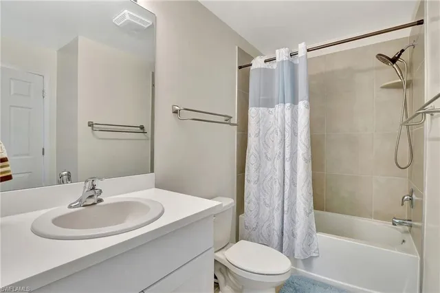 a bedroom with bed and wooden floor