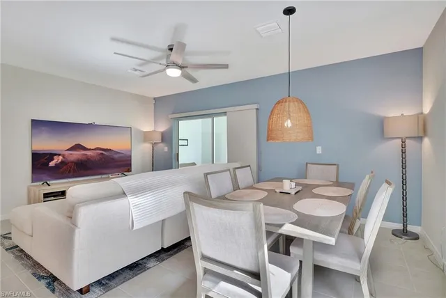 a room with a sink chandelier and a dining table with wooden floor