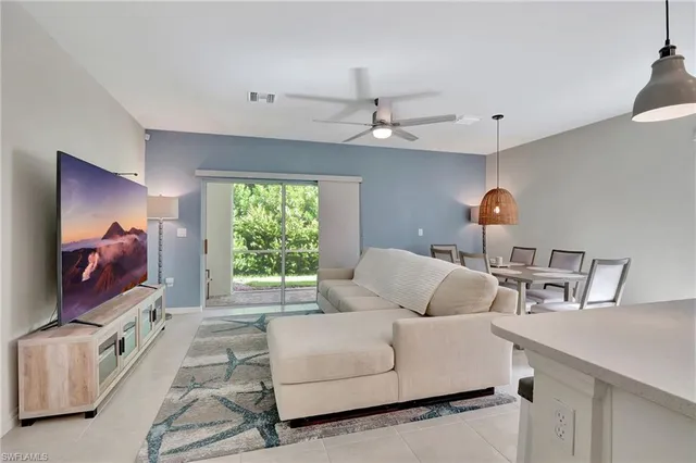 a view of a dining room with furniture and a chandelier fan
