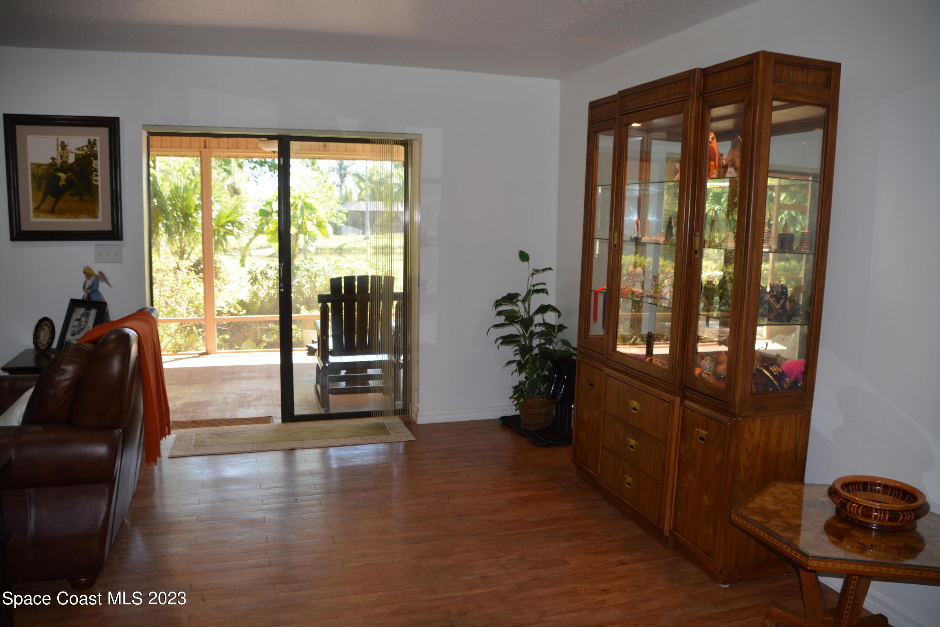 1045 Pine Island Road Merritt Island, FL 32953 - Photo 11 of 42 a living room with furniture and large windows