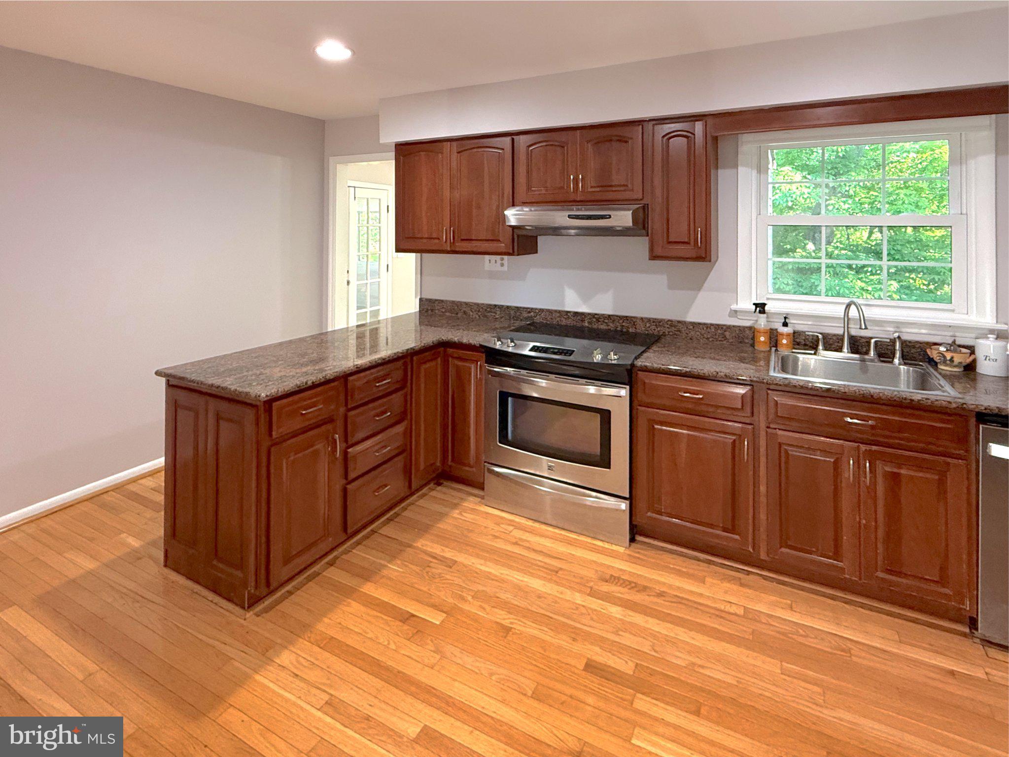 9006 Sidehill Road Ellicott City, MD 21042 - Photo 20 of 53 Modern kitchen with rich wood accents.