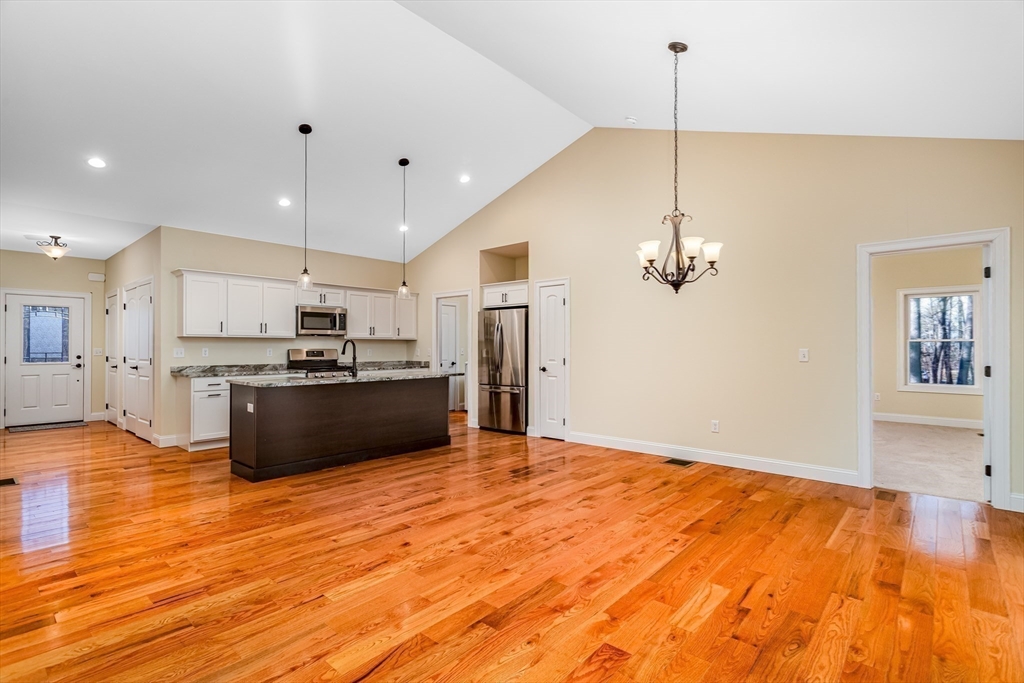 66 New Salem Road Petersham, MA 01366 - Photo 13 of 28 a large kitchen with kitchen island a stove a sink a center island a refrigerator and a wooden floor