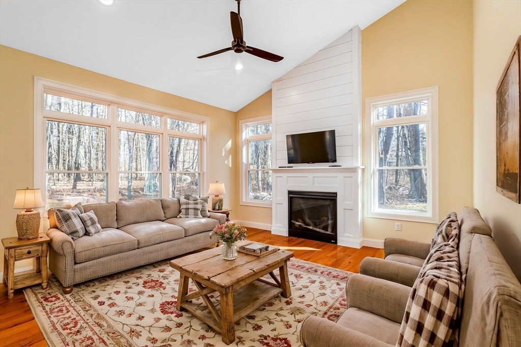 66 New Salem Road Petersham, MA 01366 - Photo 8 of 28 a living room with furniture a flat screen tv and a fireplace