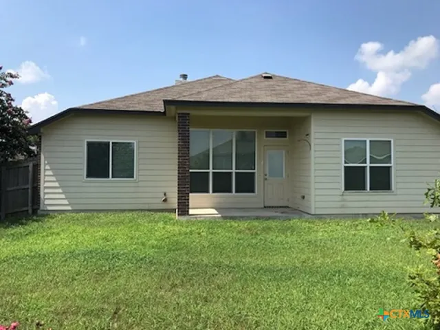 a front view of a house with a garden and yard