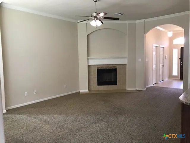 a view of empty room with fireplace