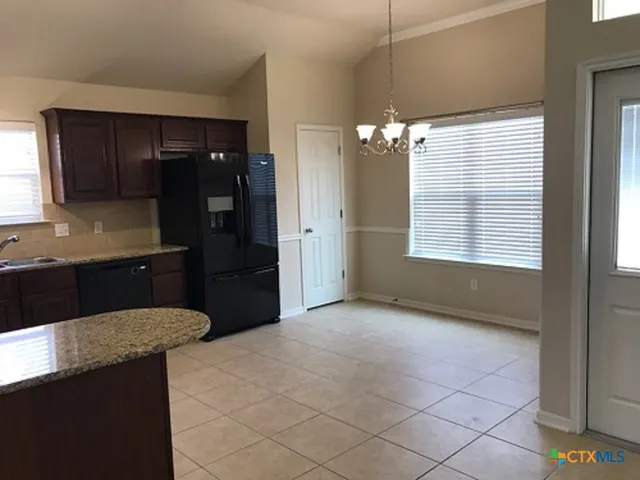 a kitchen with kitchen island a counter top space and a sink