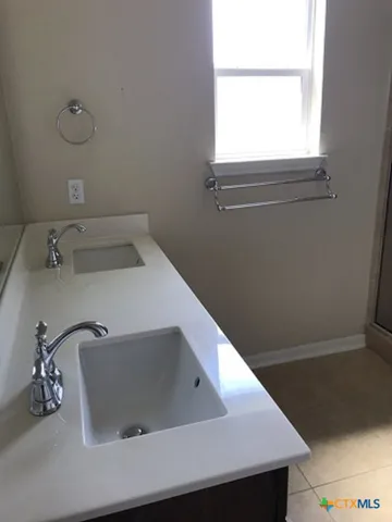 a bathroom with a sink and a window