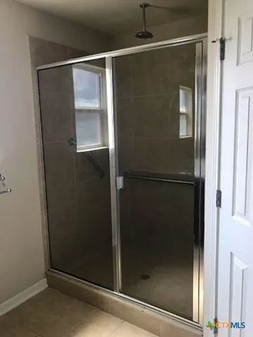 a bathroom with a glass shower door