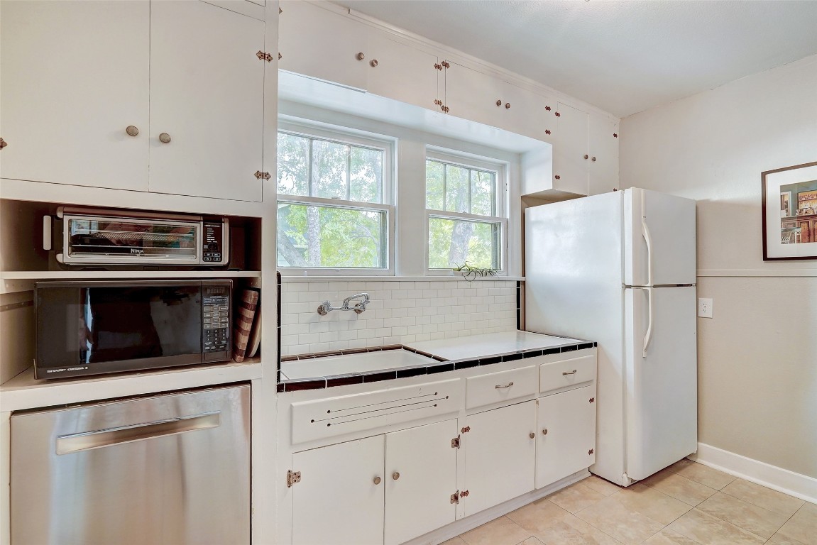 5204 Huisache Street, Unit 1 Austin, TX 78751 - Photo 8 of 23 a kitchen with appliances cabinets and a window