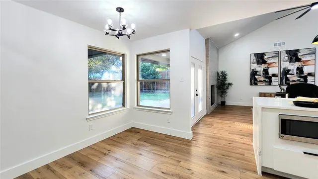 a view of a room with wooden floor and a window