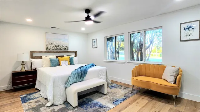 a bedroom with furniture and wooden floor